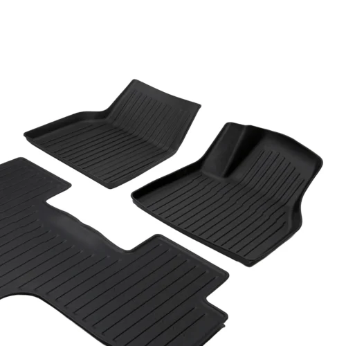 Set of four black rubber car floor mats with ribbed tread patterns for front and rear seating areas.