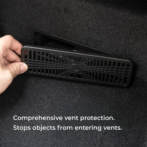 Hand installing a black vent cover over a car trunk vent to prevent debris from entering the vent material.