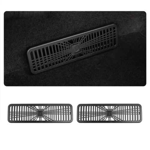 Rectangular vent cover with vertical slats and a circular center hub on dark carpeted surface