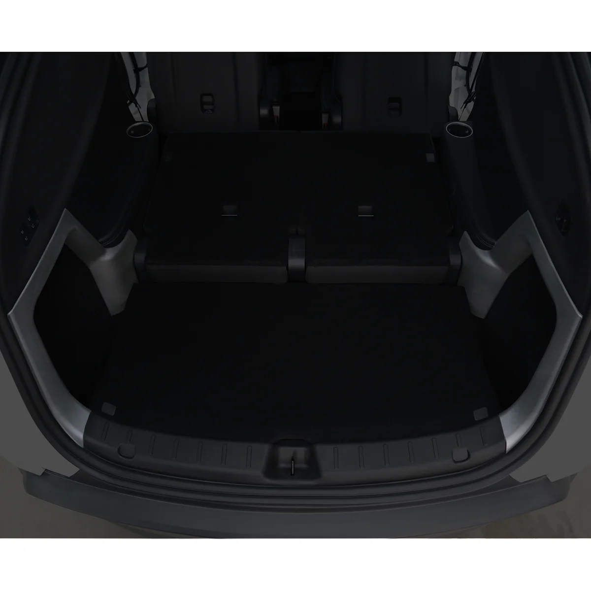 Flat cargo floor in the rear of a vehicle with folded rear seats, creating a large luggage area.