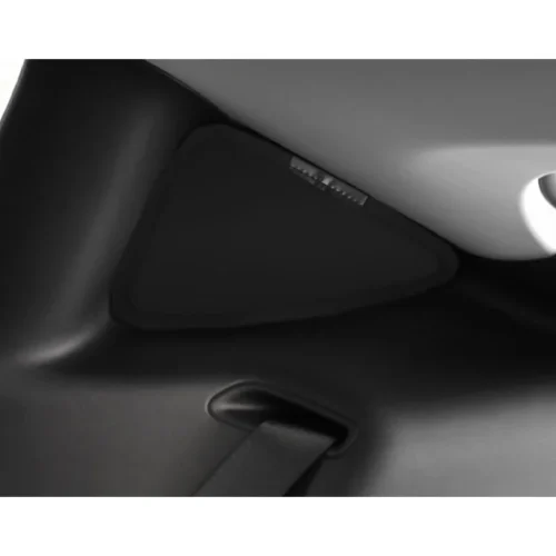 Close-up of a black plastic car interior component with a strap threading through a slot to secure a panel.