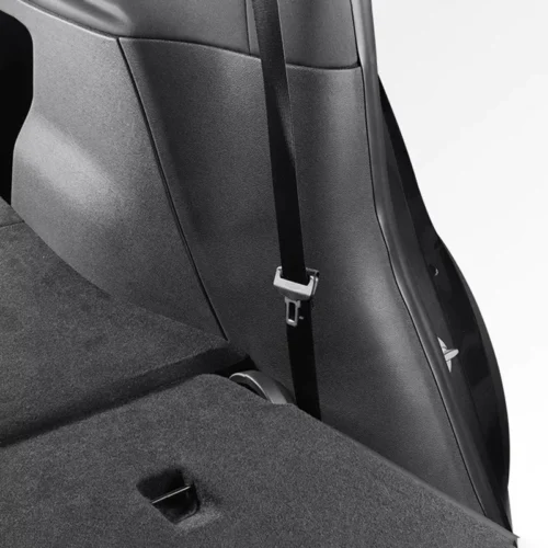 Close-up of a car interior showing a vertical seat belt with buckle attached to the seatback.