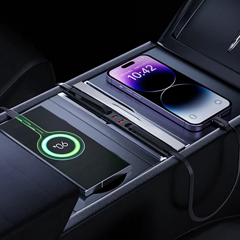 In-car wireless charging hub with an iPhone charging on the pad and another device charging nearby with a glowing indicator