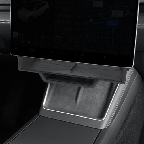 Tablet mounted on the car's center console displaying navigation/map screen and controls above a storage tray