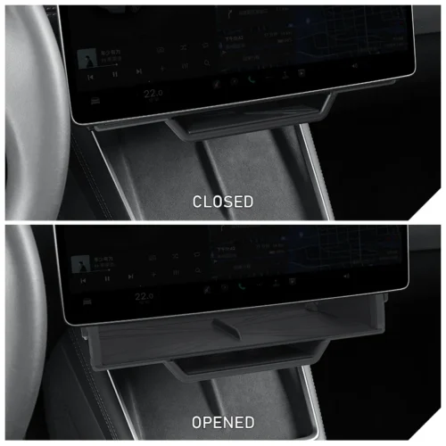 Car interior: a closed center console storage tray under the dashboard touchscreen.