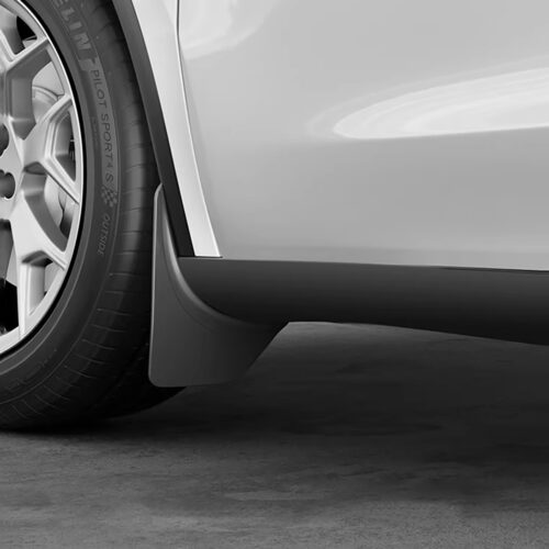 Close-up of a car's front wheel and lower body, showing the tire and side skirt on a silver vehicle.