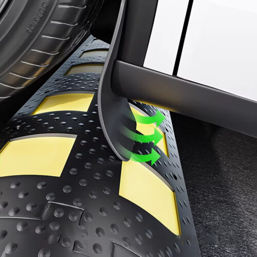 Close-up of a tire rolling over a perforated, textured surface with yellow panels, arrows indicating rotation direction near the contact area