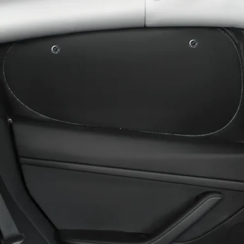 Black car door interior panel with a curved stitched outline and two circular fasteners near the top edge.