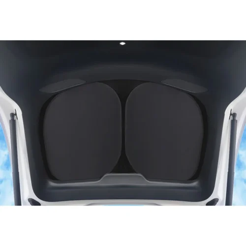 Open car trunk showing folded rear seat backs forming a flat cargo area, viewed from above in a white vehicle