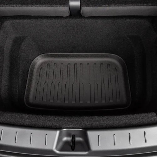 Car trunk cargo area with a black rubber mat covering the floor