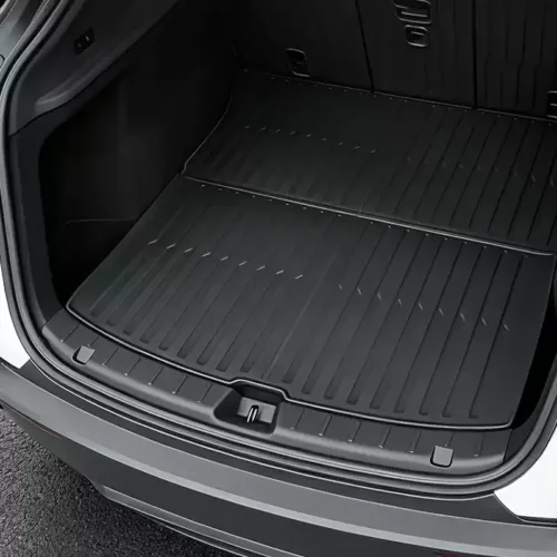 Open SUV trunk showing a textured, all-weather cargo mat covering the floor area below split rear seats.