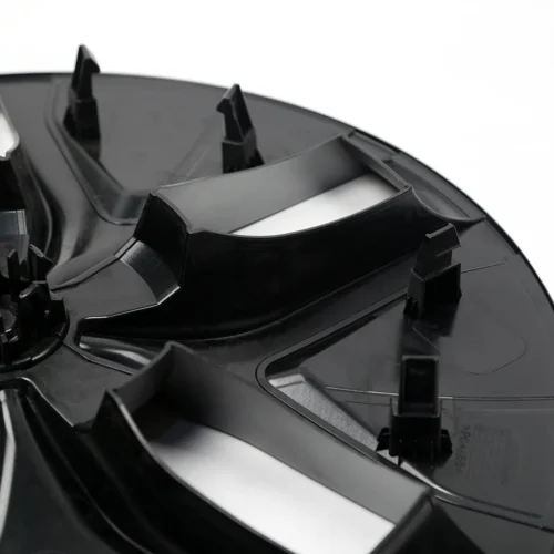 Close-up of a black plastic component with multiple mounting clips and curved ridges.
