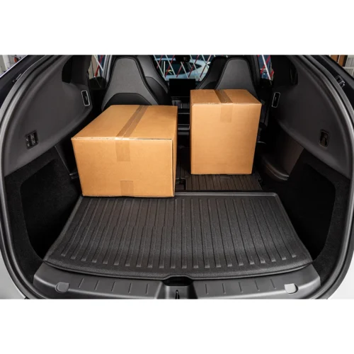 Two cardboard boxes loaded in the rear cargo area of a hatchback car