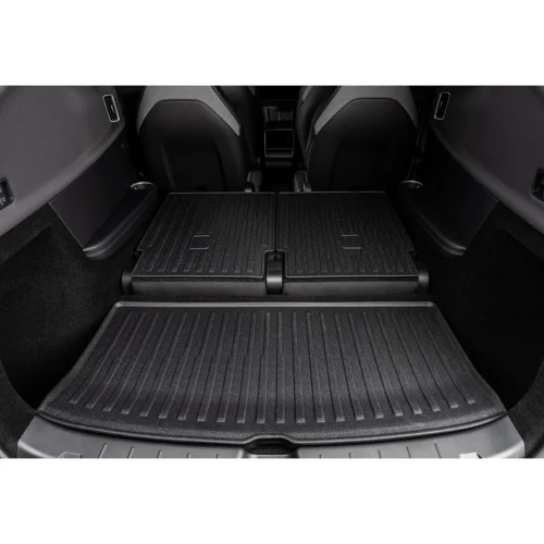 Car cargo area with folded rear seats and all-weather rubber trunk mat in place