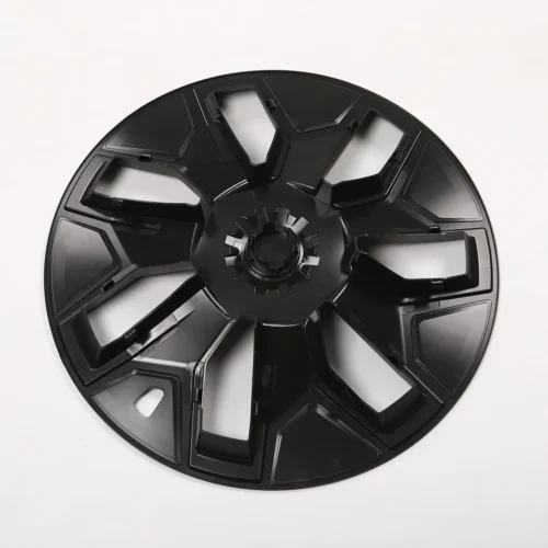 Black plastic circular wheel hub with eight wide spokes and a gear-like center on a white background.