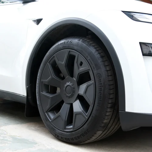 Close-up of a white car's front wheel with a dark gray alloy rim and a Continental tire rim detail visible at the wheel well