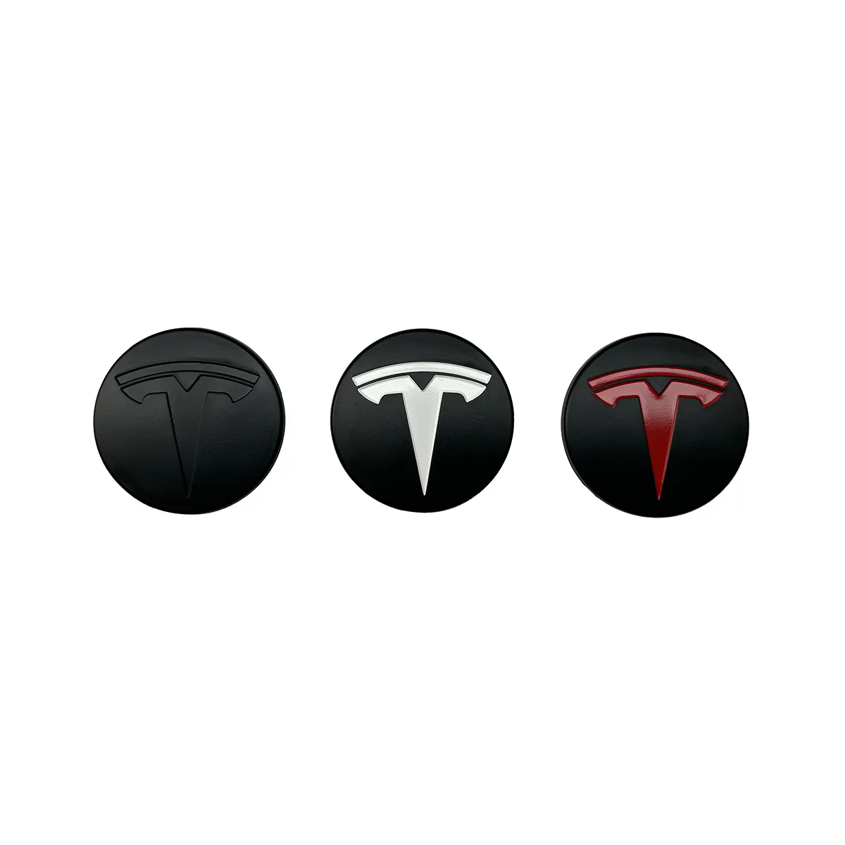 Row of three round Tesla logos on black discs: left dark emblem, center silver, right red.